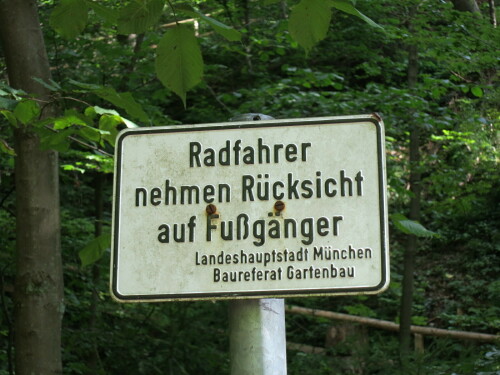 Schild "Radfahrer nehmen Rücksicht auf Fußgänger - Landeshauptstadt München - Baureferat Gartenbau"
